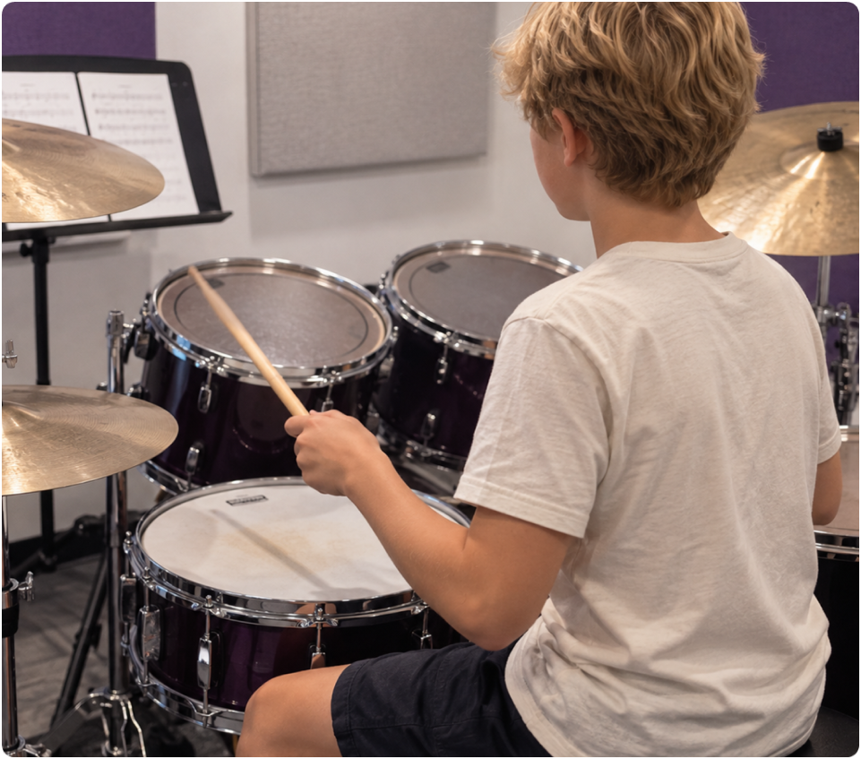 Young student playing a drum kit